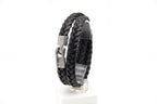 Pulsera Trenza doble de cuero negro en pedestal